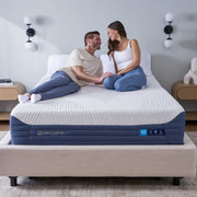 Couple sitting on a BEDGEAR H2 mattress