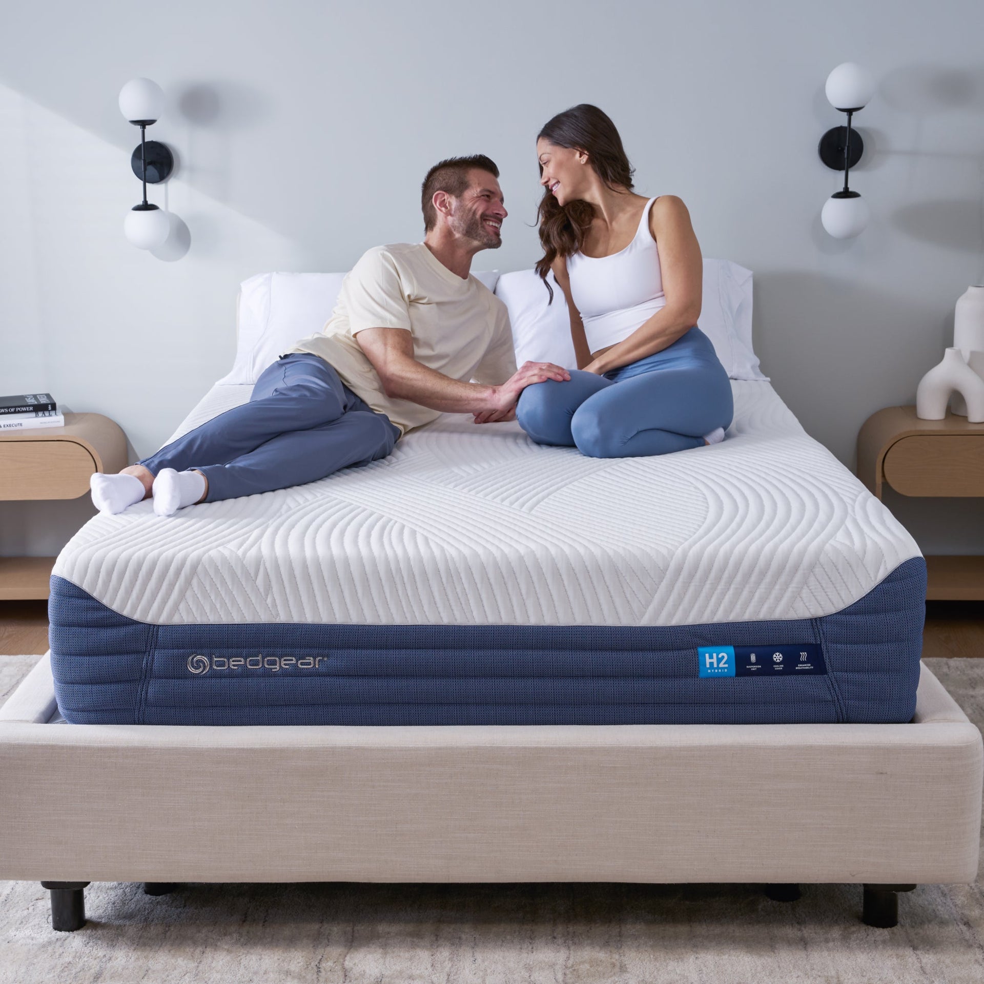 Couple sitting on a BEDGEAR H2 mattress