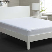 A stretchwick mattress protector on a white bed. 