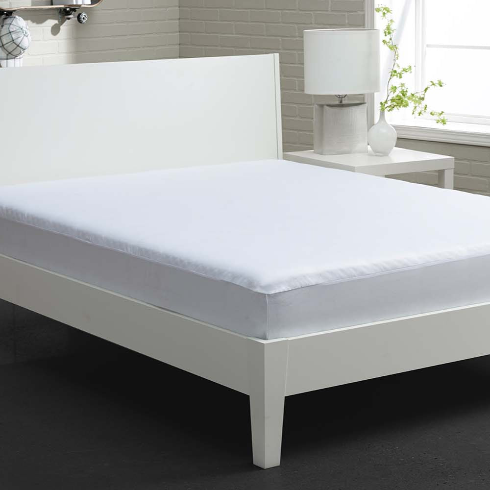 A stretchwick mattress protector on a white bed. 