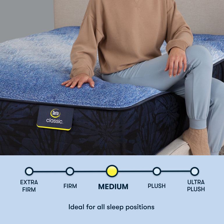 Person sitting on edge of Classic Brecon Medium Serta mattress | Ideal for all sleep positions with medium firmness