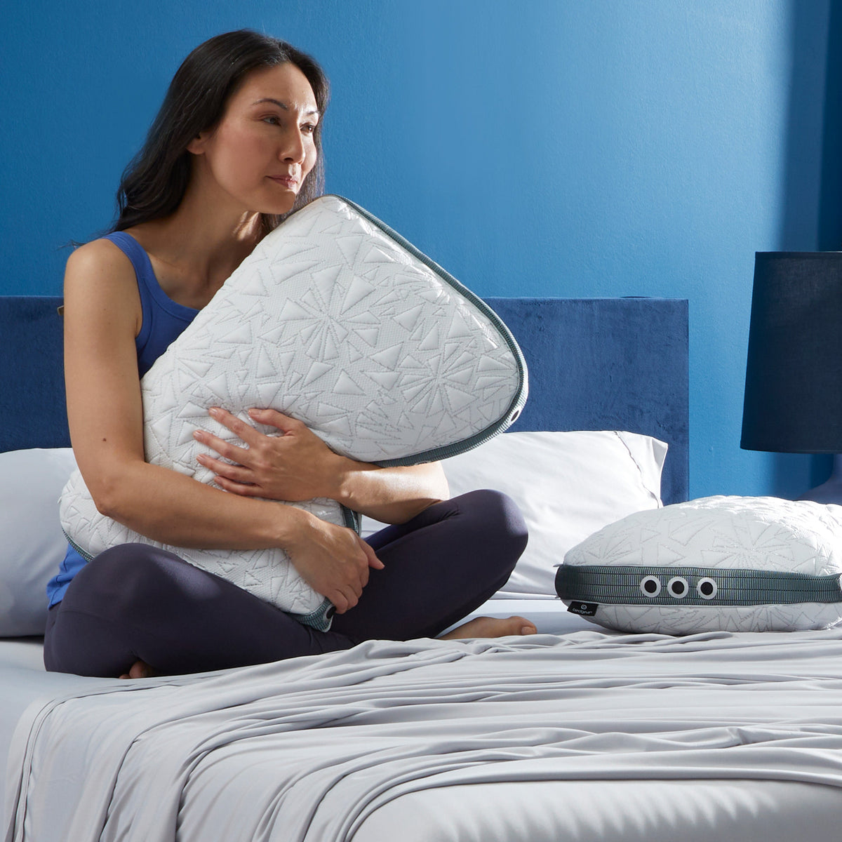 BEDGEAR Storm Cuddle Curve Pillow on a bed