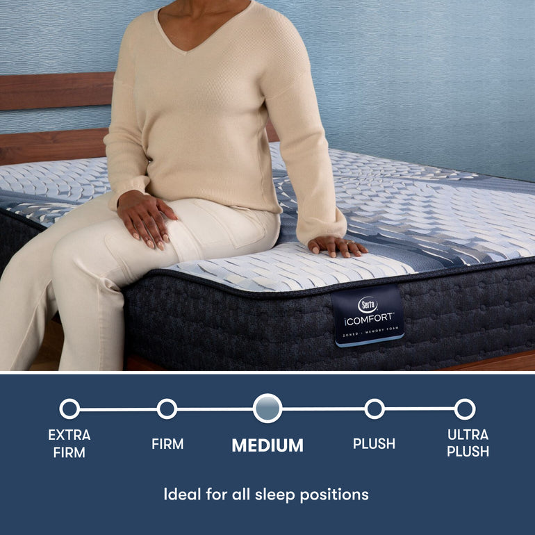 Woman sitting on edge of iComfort Iona Medium mattress by Serta | Designed for all sleep positions