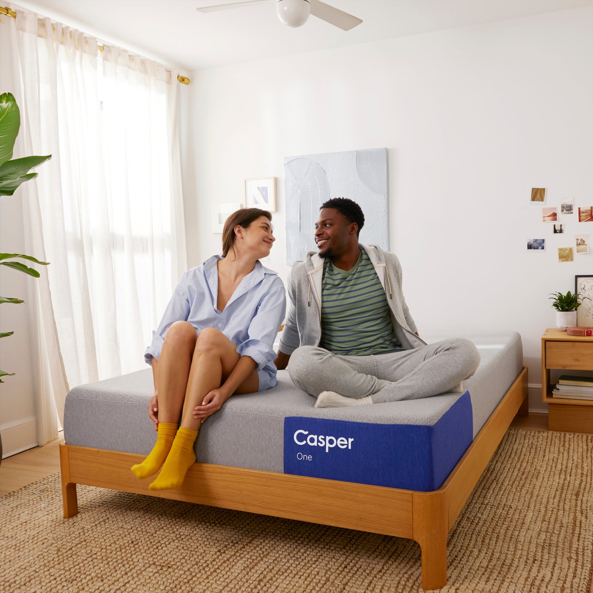 Couple sitting on The One Mattress by Casper | Breathable foam and pressure-relieving support