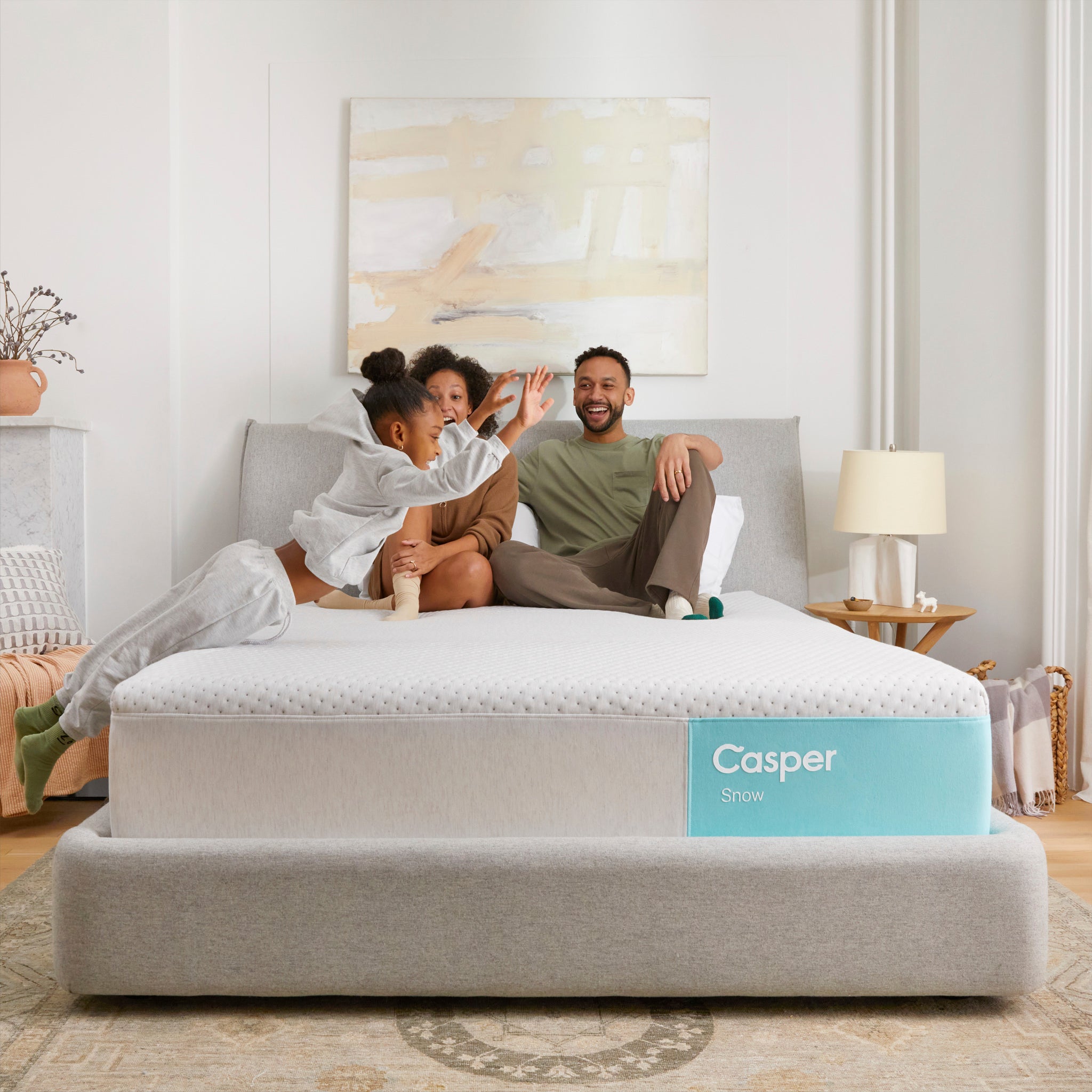 Family relaxing on Snow Mattress by Casper | Cooling comfort with Zoned Support for all sleepers